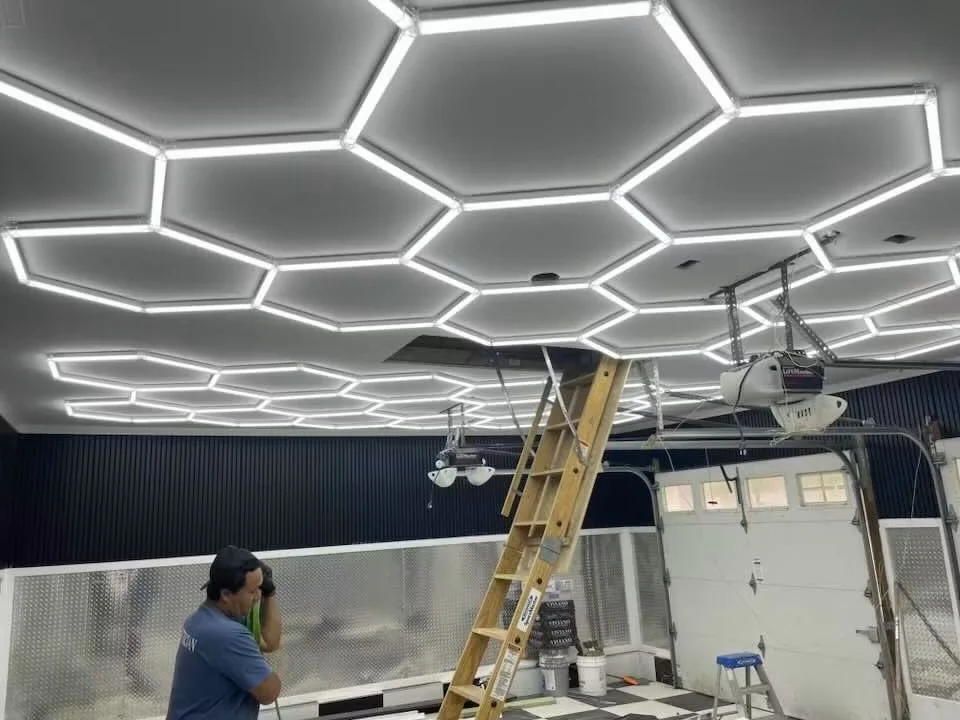 Illuminated hexagonal ceiling lights in a garage during installation
