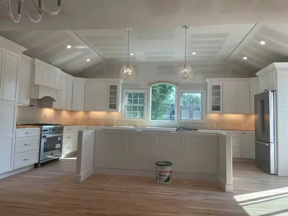 Pendant, recessed and under-cabinet lights in a white kitchen during renovation