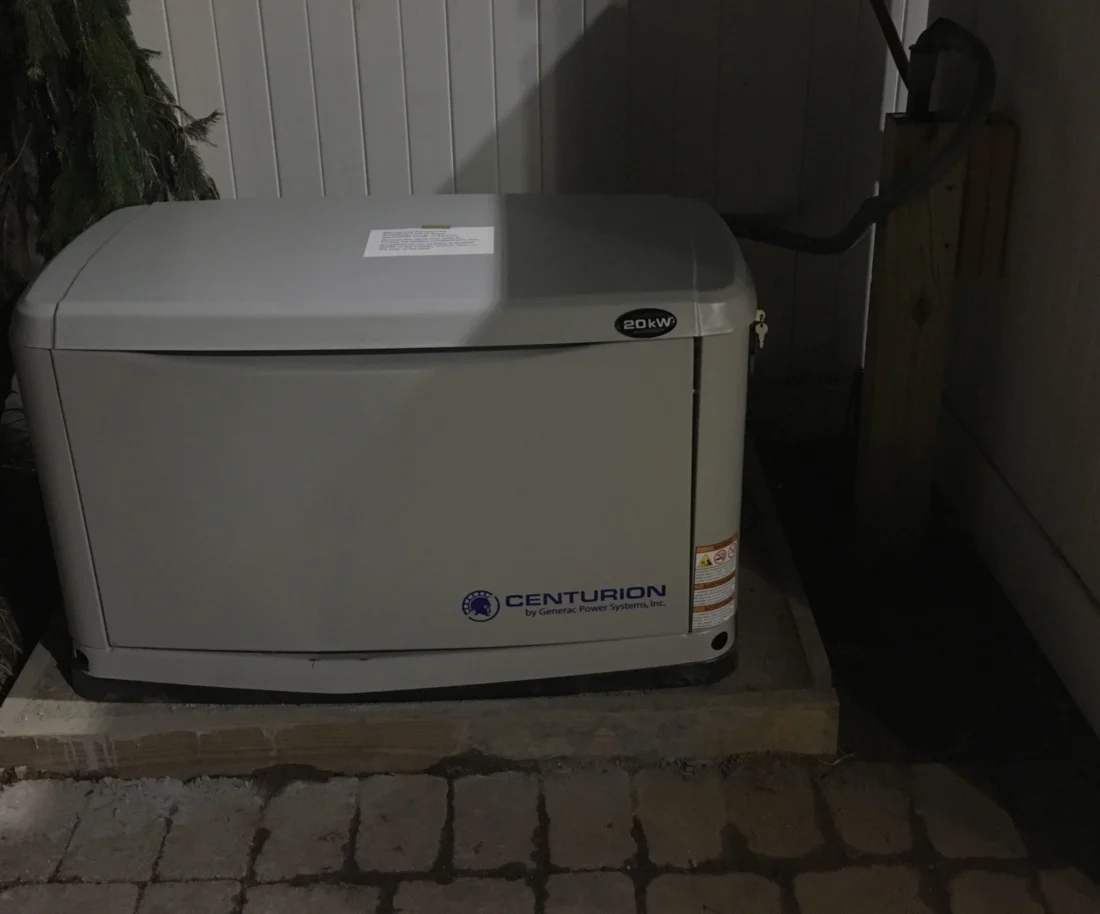 Standby generator installed beside a home